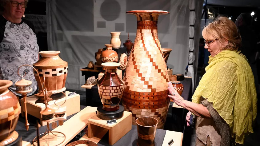 Attendee admiring an artist's work at ArtFest Fort Myers 2022